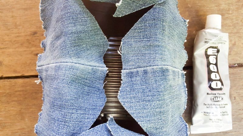 Use E6000 to glue the denim or fabric shapes onto and around the opening in the tin can.