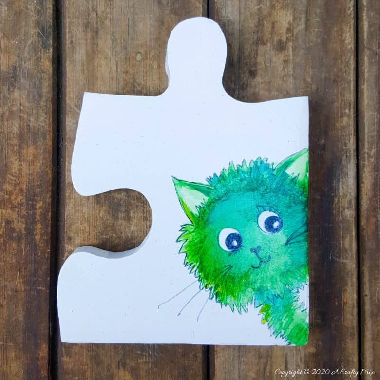 Best DIY Gift Idea EVER!!! Curious Kitty Puzzle Pieces that can be used as coasters or a platter. The full tutorial will show you how to make your own and includes a free template for the puzzle as well as all four kitties. #PuzzleCoasters #DIYGiftIdea #ACraftyMix #PuzzlePlatter ##DIYPuzzle #FreePrintable