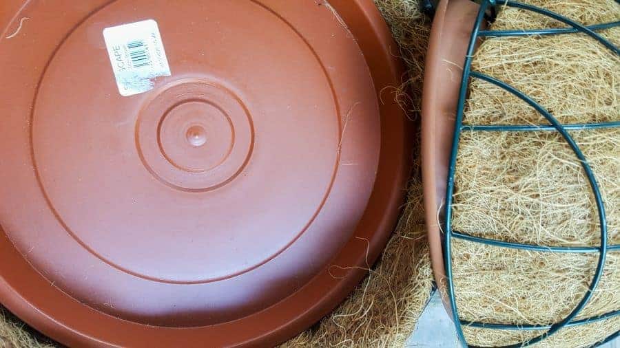 Two hanging wire baskets and drainage plates that fit snuggly inside
