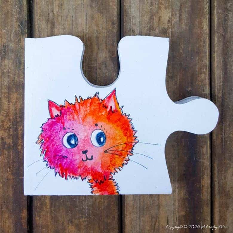 Best DIY Gift Idea EVER!!! Curious Kitty Puzzle Pieces that can be used as coasters or a platter. The full tutorial will show you how to make your own and includes a free template for the puzzle as well as all four kitties. #PuzzleCoasters #DIYGiftIdea #ACraftyMix #PuzzlePlatter ##DIYPuzzle #FreePrintable