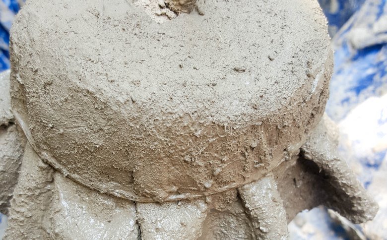 Drape the concrete fabric over the mushroom stalk and secure with a rubber band