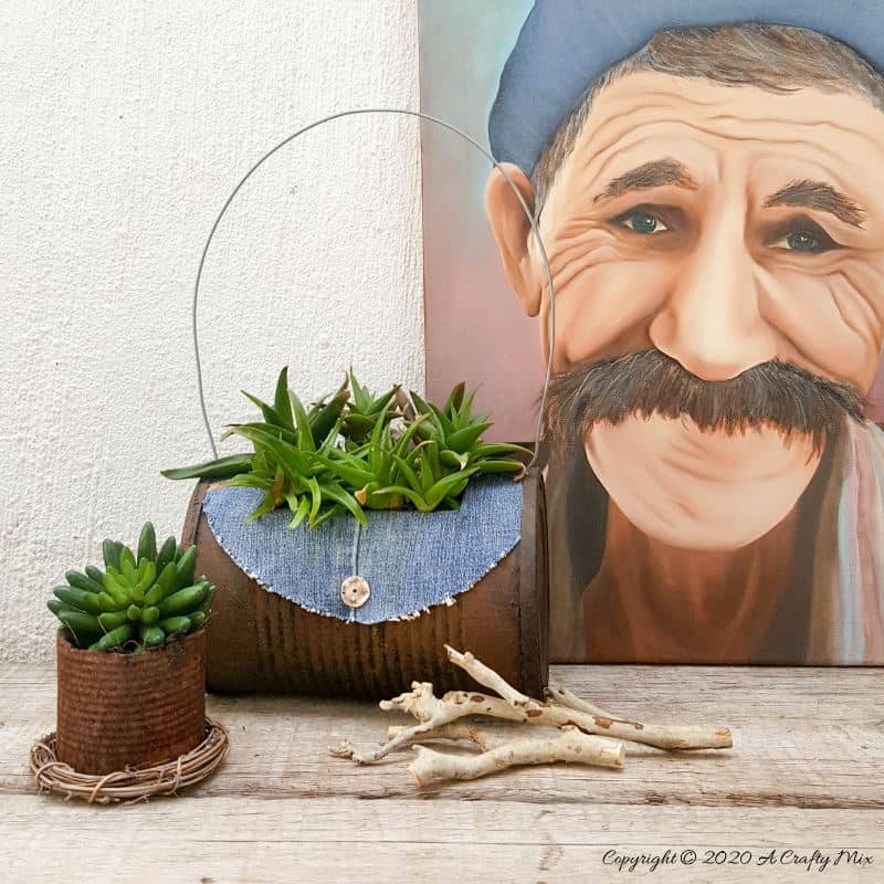I love recycling tin cans into planters like this one. We call it the rusty tin can barrel bag planter. Quite a mouth full but it&rsquo;s really easy to do with things you would normally throw away.  #Barrelbag #TinCanRepupose #ACraftyMix #DIYPlanter #TinCanPlanter #recycledtincan #DenimCrafts