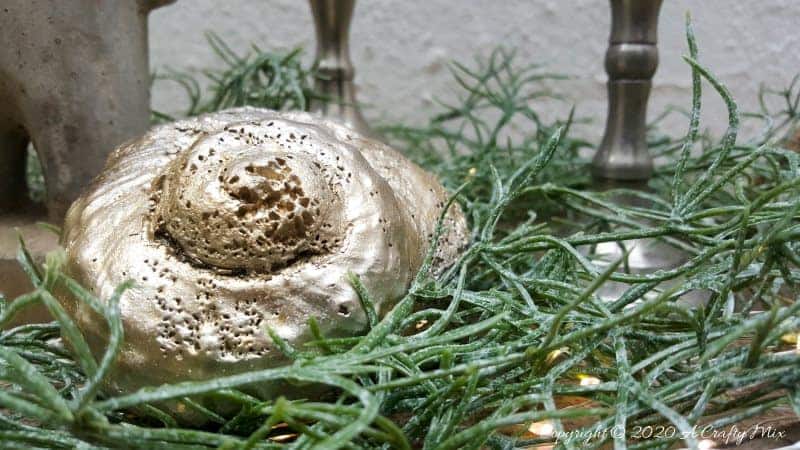 The repurposed wine glasses can be placed on a wooden tray with some Spanish Moss and fairy lights for a beautiful display