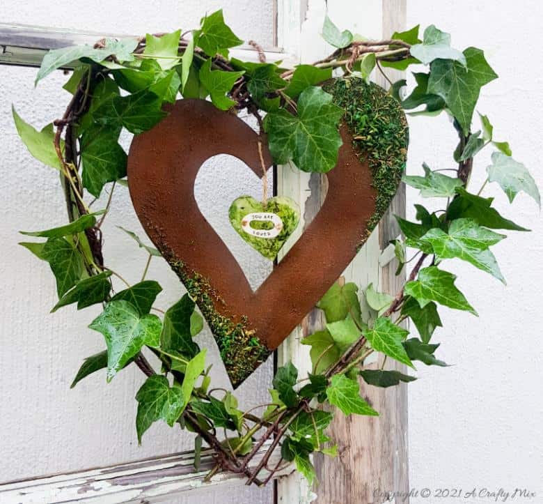 Celebrate the arrival of the most beautiful season of all and make this gorgeous Spring heart wreath. All that luscious greenery promises that the cold, miserable days of winter are almost over and that Spring is on her way, bursting with life and new growth. #SpringWreath #HeartWreath #ACraftyMix #DIYWreath #FreshIvy #ValentinesDay