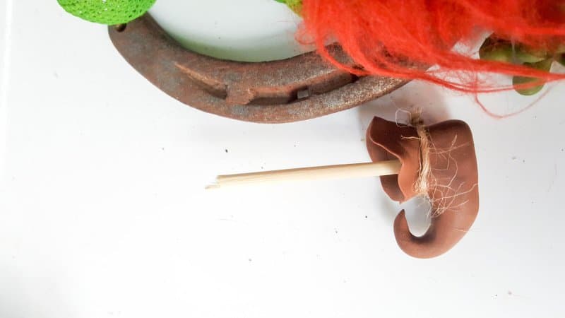 Insert a cut skewer into the clay shoe and leave to dry