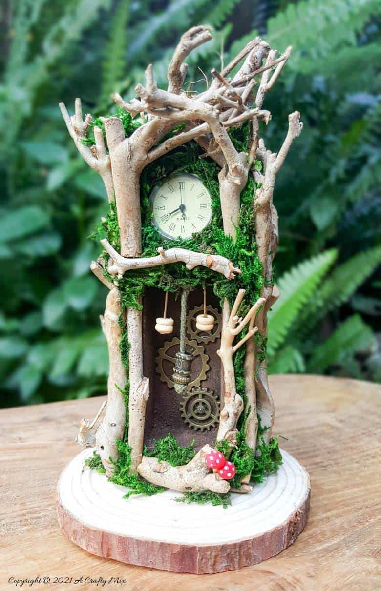 Have you ever wanted to make a real working fairy grandfather clock? This tutorial will show you how and includes a downloadable template along with instructions to make teeny, tiny mushrooms and a fairy bird&rsquo;s nest. #FairyCrafts #ACraftyMix #MiniatureGrandfatherClock