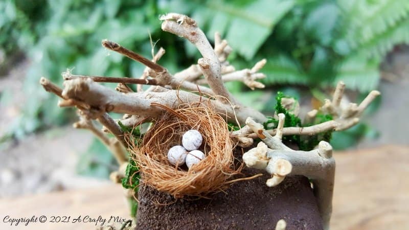 Have you ever wanted to make a real working fairy grandfather clock? This tutorial will show you how and includes a downloadable template along with instructions to make teeny, tiny mushrooms and a fairy bird&rsquo;s nest. #FairyCrafts #ACraftyMix #MiniatureGrandfatherClock