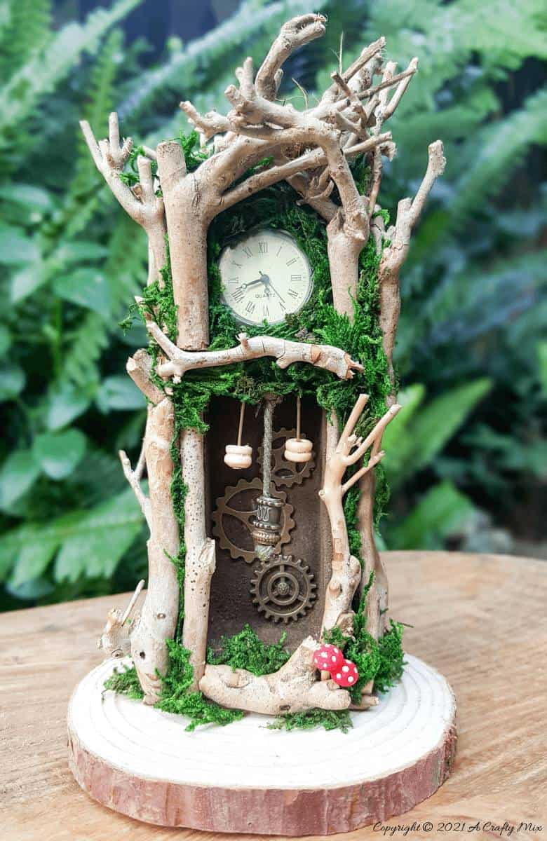 Have you ever wanted to make a real working fairy grandfather clock? This tutorial will show you how and includes a downloadable template along with instructions to make teeny, tiny mushrooms and a fairy bird’s nest. #FairyCrafts #ACraftyMix #MiniatureGrandfatherClock