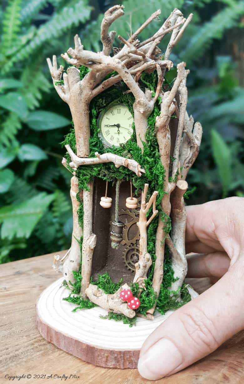Have you ever wanted to make a real working fairy grandfather clock? This tutorial will show you how and includes a downloadable template along with instructions to make teeny, tiny mushrooms and a fairy bird&rsquo;s nest. #FairyCrafts #ACraftyMix #MiniatureGrandfatherClock