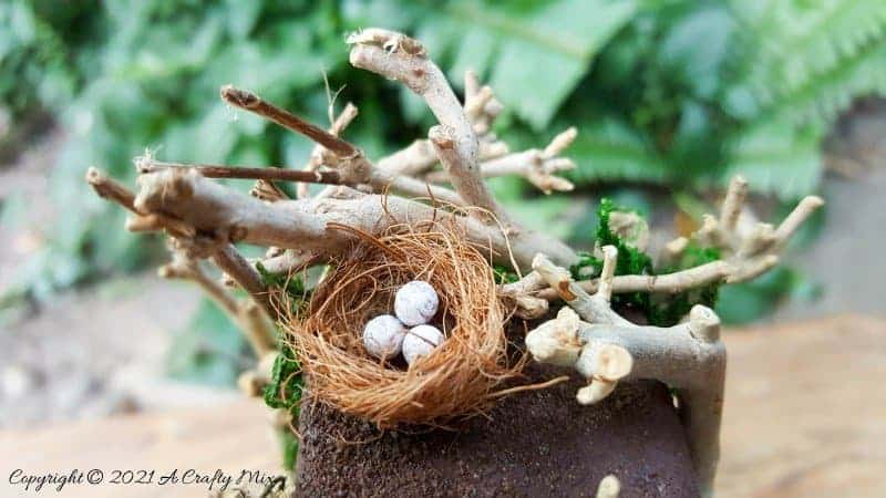 Have you ever wanted to make a real working fairy grandfather clock? This tutorial will show you how and includes a downloadable template along with instructions to make teeny, tiny mushrooms and a fairy bird&rsquo;s nest. #FairyCrafts #ACraftyMix #MiniatureGrandfatherClock