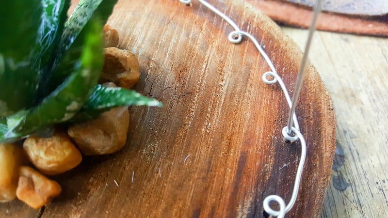 Insert cut wire into the holes in the slice and through the little loops