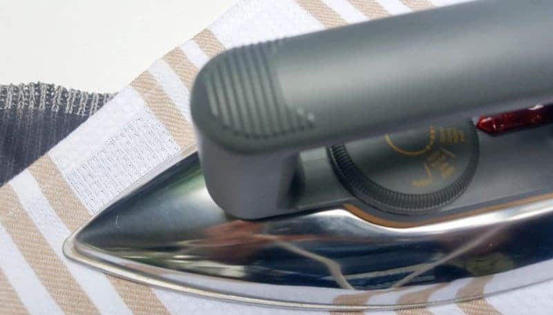 Use the wool setting on your iron to "glue" the interfacing to the sweater