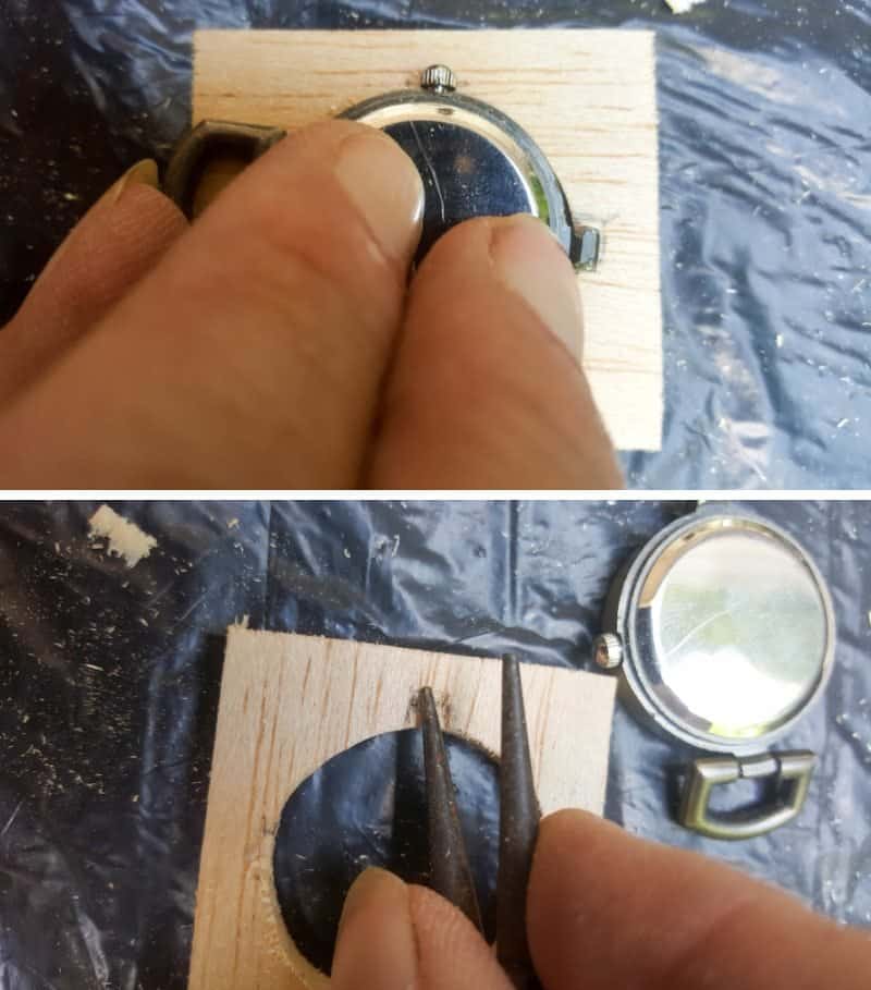 On the back of the balsa wood push the clock face in to make small indents