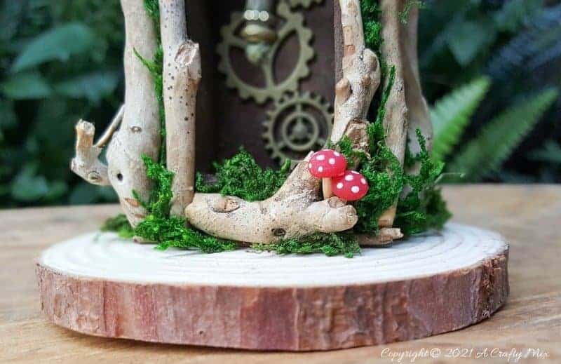 Have you ever wanted to make a real working fairy grandfather clock? This tutorial will show you how and includes a downloadable template along with instructions to make teeny, tiny mushrooms and a fairy bird&rsquo;s nest. #FairyCrafts #ACraftyMix #MiniatureGrandfatherClock