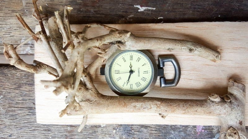 Position the clock face towards the top of the rectangle and play around with the twigs until you're happy with the layout