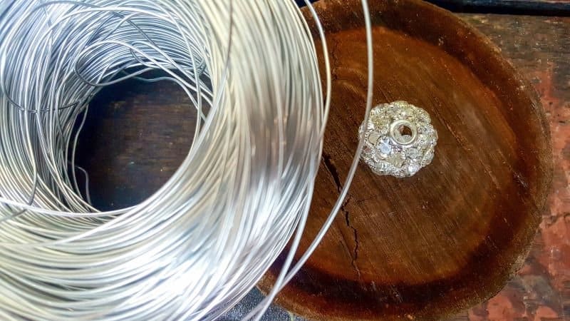 To make the art deco wire birdcage you'll need wire, some sort of base and a large crystal bead