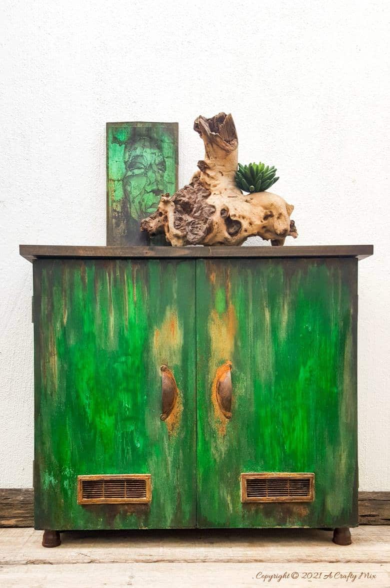 Ever found a cheap melamine cupboard at the thrift store that was just to &ldquo;bleh&rdquo; to fit into your d&eacute;cor style? This tutorial will show you how to give it an easy faux distressed metal makeover that won&rsquo;t break the bank. #melaminmakeover #paintingmelamine #acraftymix #fauxmetal #UnicornSpit
