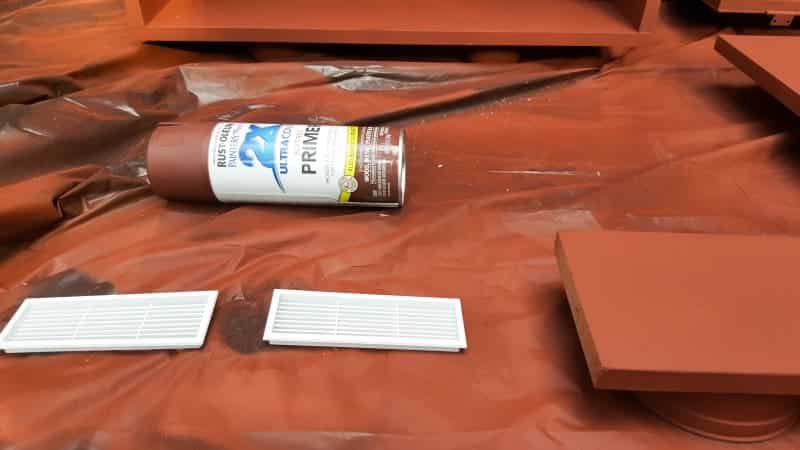 Hand sand the melamine lightly with 120 grit sandpaper before painting
