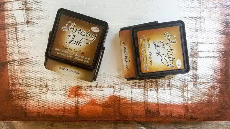 Use distress inks and paint to disguise the white edges of the canvas