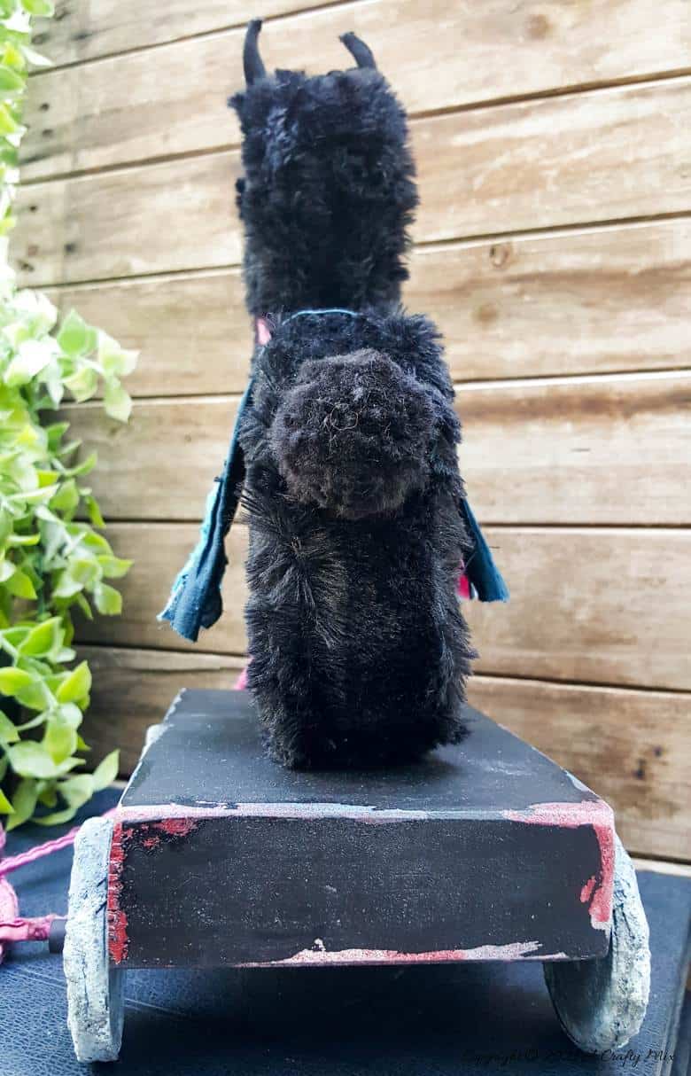 In the tradition of old toys we made this DIY Pull Toy llama using upcycled tin can wheels. This fun recycled craft idea comes with a free printable llama template. #Upcycle #TinCan #ACraftyMix #PullToy #HomeDecor