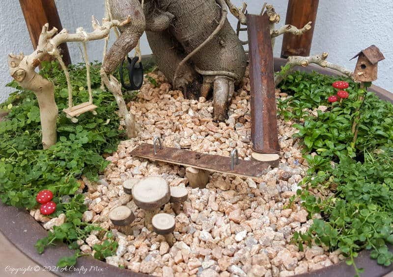 This photo-rich tutorial will show you how you can make your own fairy playground using what you have in your craft cupboard. No fancy tools needed and everything can be made in a morning #FairyGarden, #ACraftyMix, #Playground