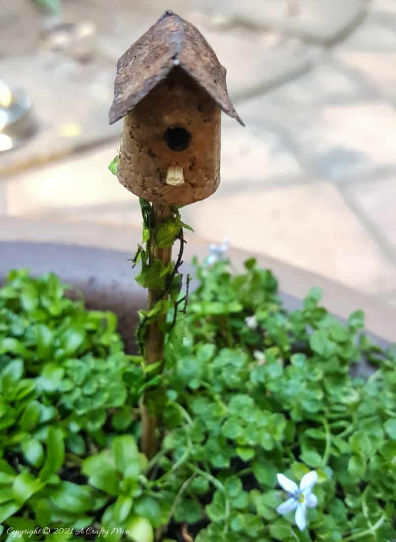 Place the fairy birdhouse in the soil