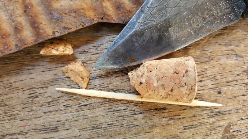 Cut the top of the cork and glue on a scrap piece of rusty metal