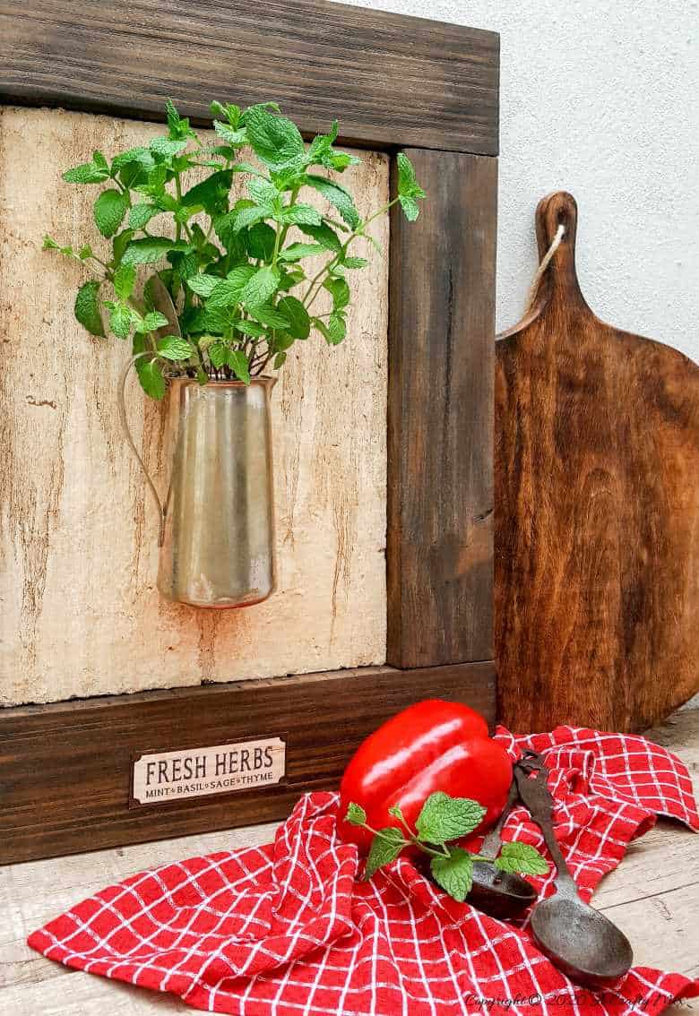 I love this fresh twist on the traditional herb garden. The framed bouquet of fresh herbs can be propped on the counter or hang it up if you prefer to keep your counters clutter free. #IndoorHerbs #IndoorGarden #FramedGarden #ACraftyMix #DistressedWall #DistressedFrame #GardenInspiration#FreshHerbs