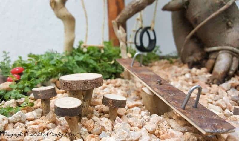 This photo-rich tutorial will show you how you can make your own fairy playground using what you have in your craft cupboard. No fancy tools needed and everything can be made in a morning #FairyGarden, #ACraftyMix, #Playground