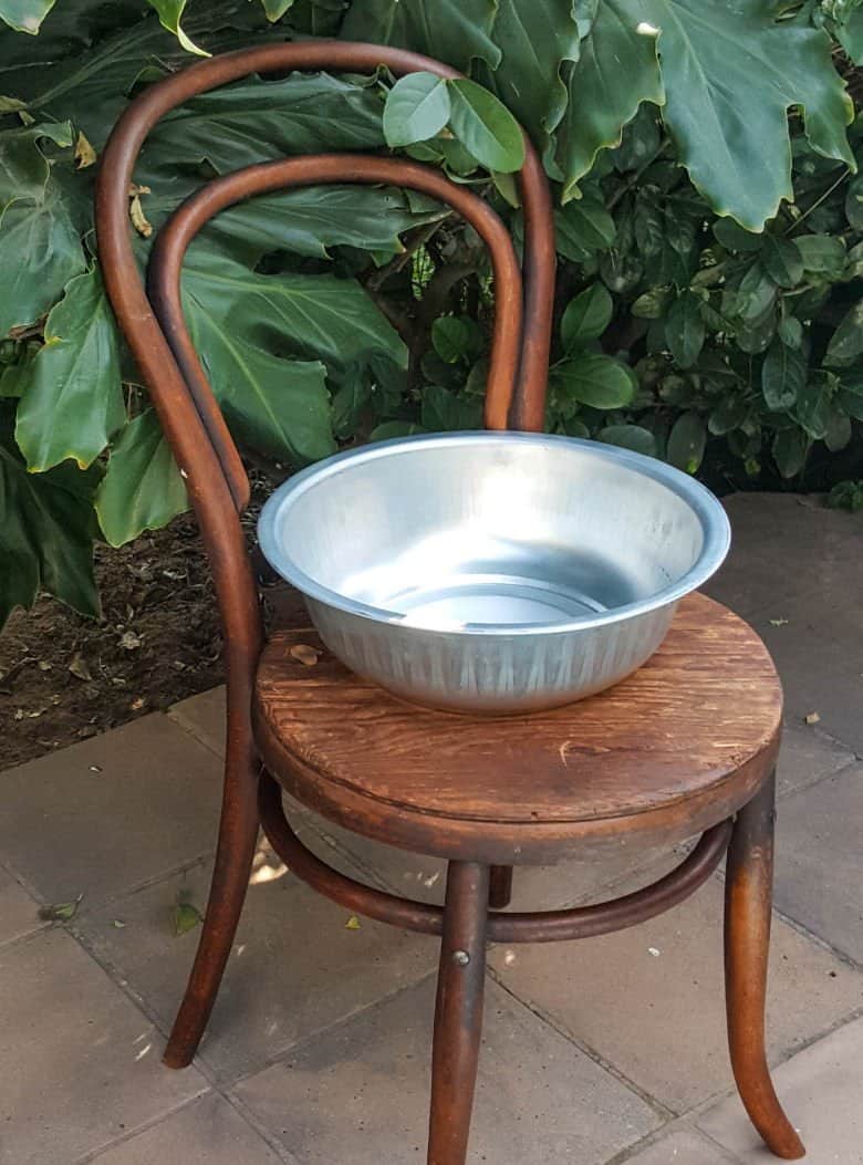 We used a broken chair and wash aluminium prep bowl to make a fairy playground