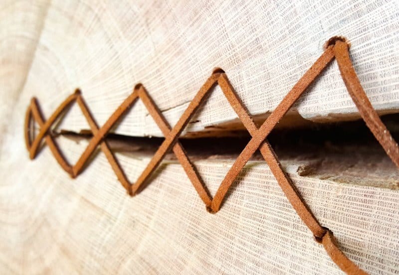 Continue adding the leather cord in the holes criss-crossing as you go