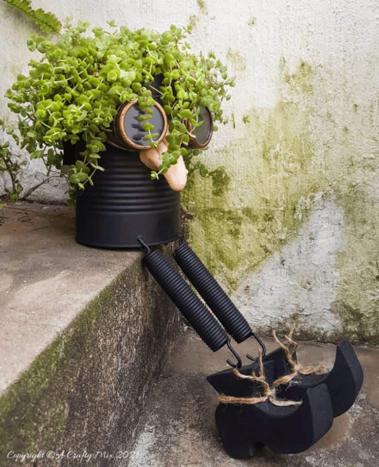 Looking for a creative way to repurpose a tin can? The  you'll love this tin can steampunk planter. We call him Dr Edinose and he's sure to add a little whimsy to your outdoor decor. #steampunkplanter #ACraftyMix #TinCanRecycle