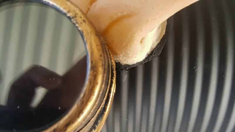 Slip the steampunk goggles over the tin can before adding the plants