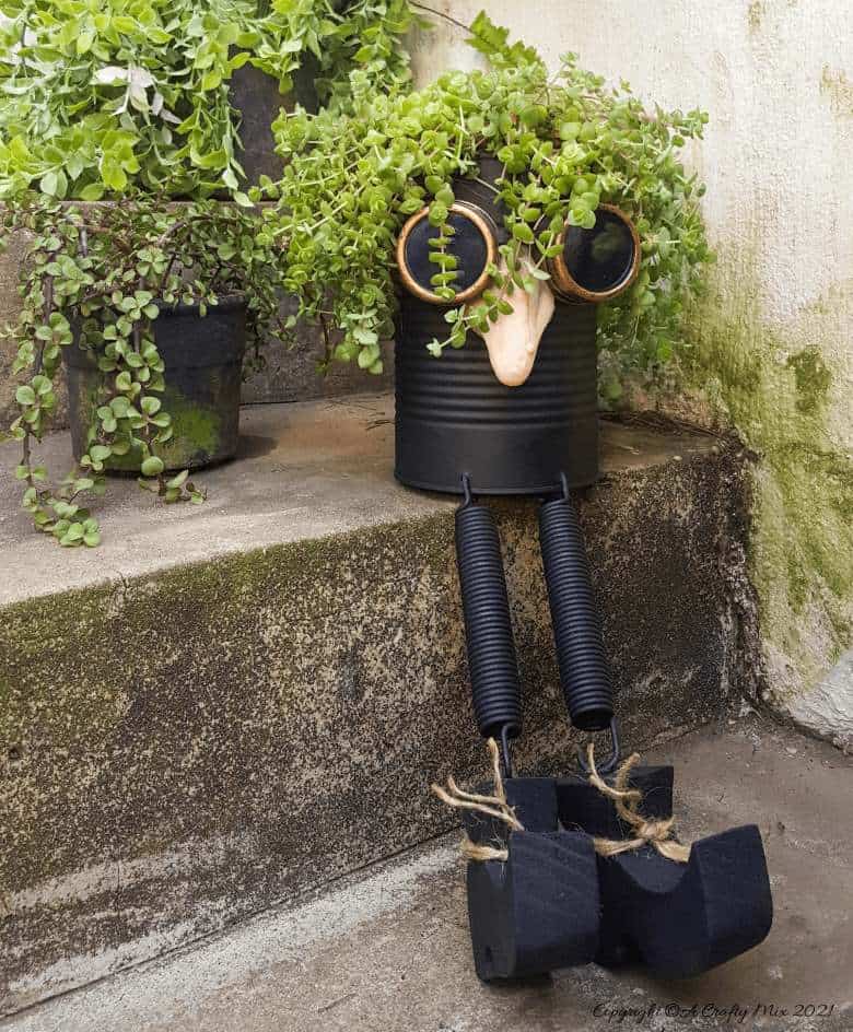 Looking for a creative way to repurpose a tin can? The  you'll love this tin can steampunk planter. We call him Dr Edinose and he's sure to add a little whimsy to your outdoor decor. #steampunkplanter #ACraftyMix #TinCanRecycle