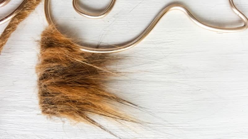 Cut a piece of twine and glue it on the bottom of the hair