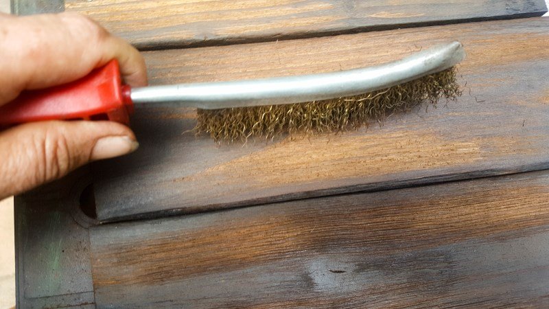 Use a wire brush or 60 grit sandpaper to remove the charred wood