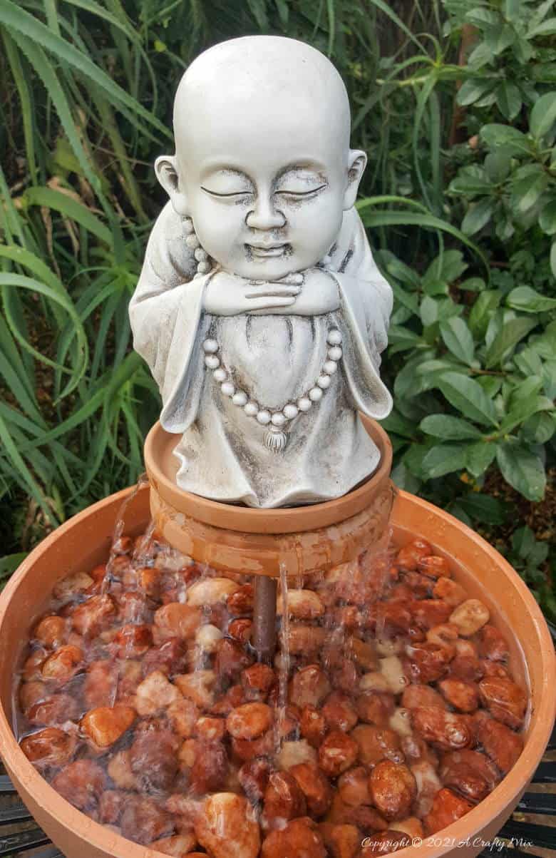 This photo-rich tutorial will show you how just how easy it is to repurpose an empty CD case and turn it in a CD spindle water feature bringing a calming, zen-like decorative feel to any space. #Spindlerepurpose #ACraftyMix #waterfeature