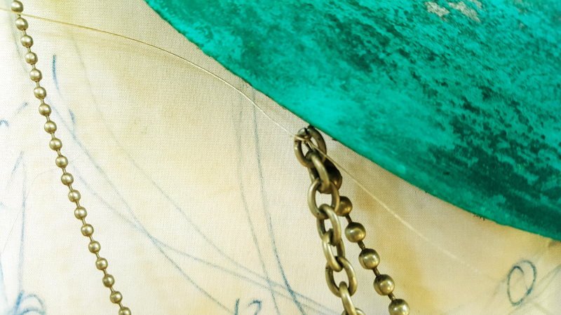 A close up view showing how the beads have been attached to the eye hooks on the dream catcher