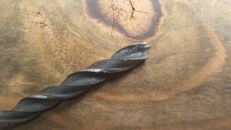 Use a large spur wood bit to drill a hole in the vase