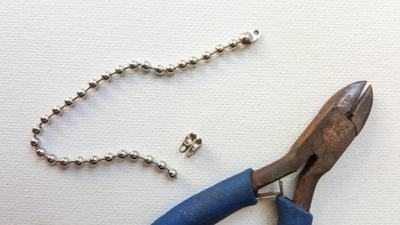 Use wire cutters to cut the ball chain to the correct length