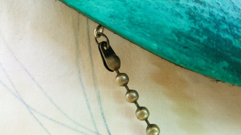 A close up view showing how the beads have been attached to the eye hooks on the dream catcher