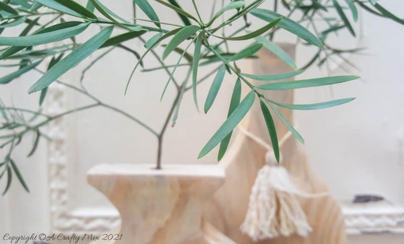 A close up of the yellow wood branches in the vase