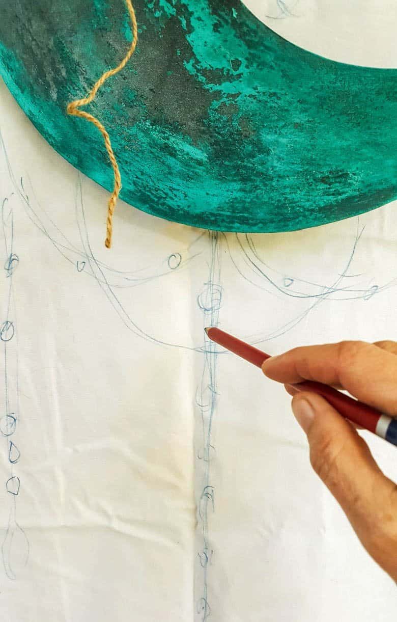 Draw a rough sketch of where to hang the beads from the half moon