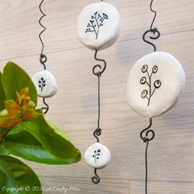 Easy budget friendly tattooed clay wall hanging that can be made in a morning. The photo rich tutorial includes free botanical printables to get you started. #WallDecor #ACraftyMix #AirDryClay