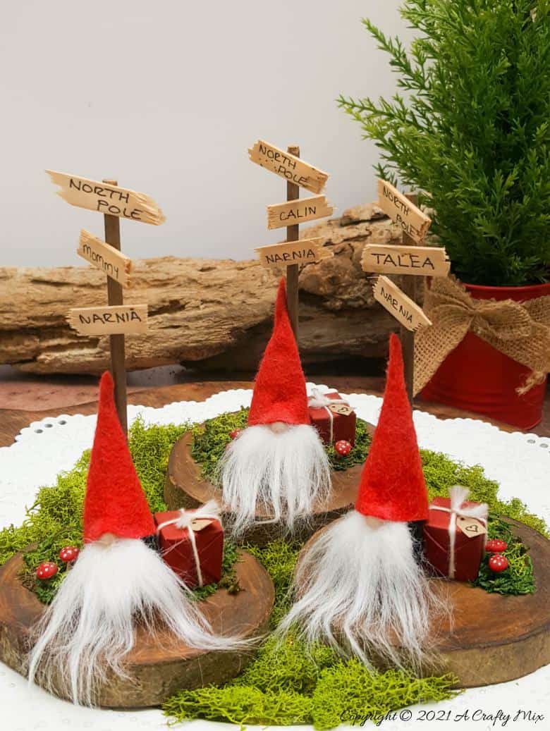 Easy 10-minute no-sew miniature sock gnome that anyone can make! Use these adorable little guys to make Christmas place card holders that your guests can take home as gifts afterwards. #sockgnome #ACraftyMix #giftideas