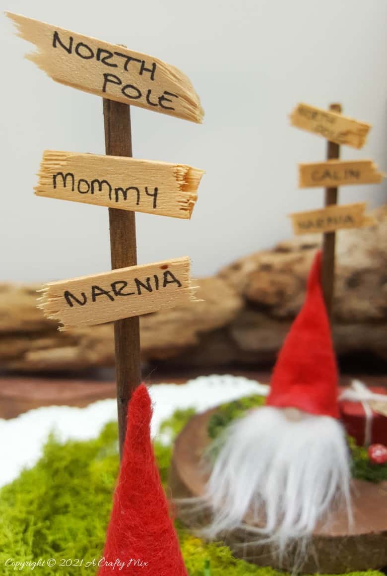 Easy 10-minute no-sew miniature sock gnome that anyone can make! Use these adorable little guys to make Christmas place card holders that your guests can take home as gifts afterwards. #sockgnome #ACraftyMix #giftideas