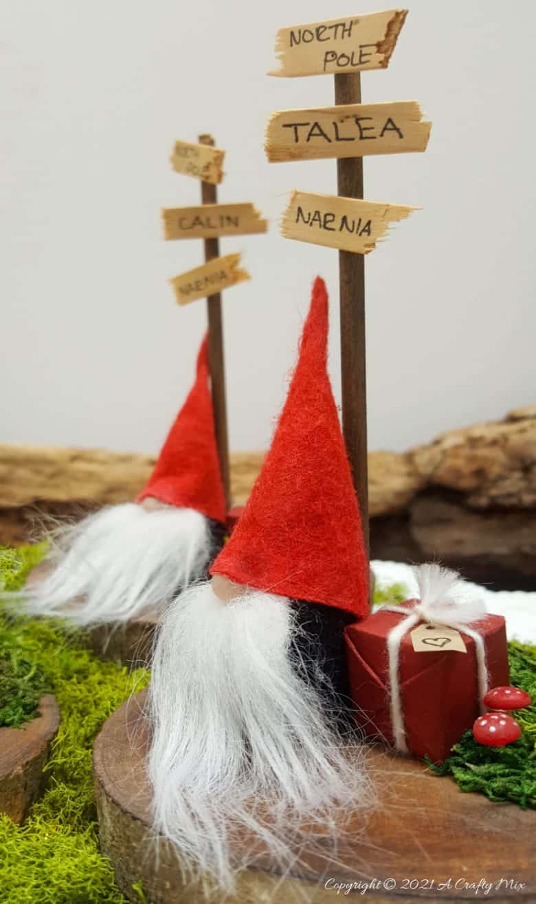 Easy 10-minute no-sew miniature sock gnome that anyone can make! Use these adorable little guys to make Christmas place card holders that your guests can take home as gifts afterwards. #sockgnome #ACraftyMix #giftideas