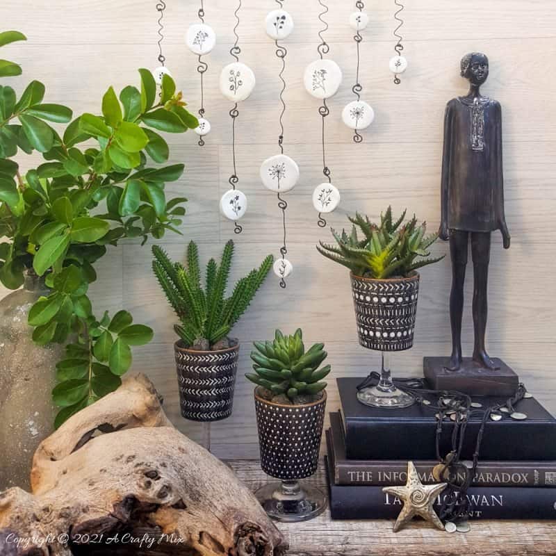 Easy budget friendly tattooed clay wall hanging that can be made in a morning. The photo rich tutorial includes free botanical printables to get you started. #WallDecor #ACraftyMix #AirDryClay