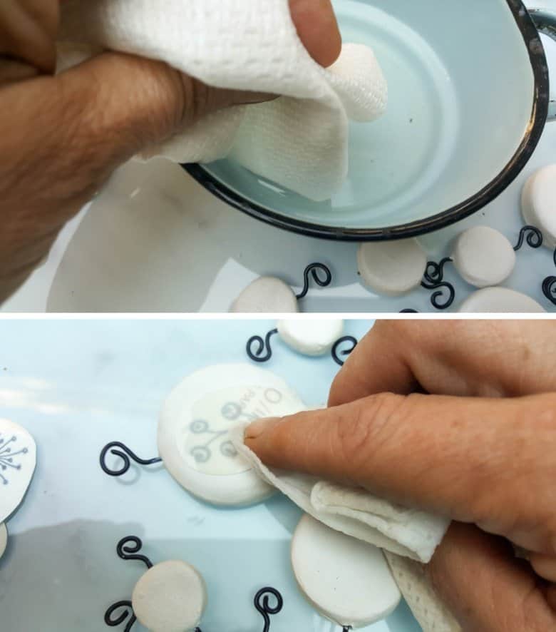 Use a damp cloth to transfer the tattoos onto the clay discs