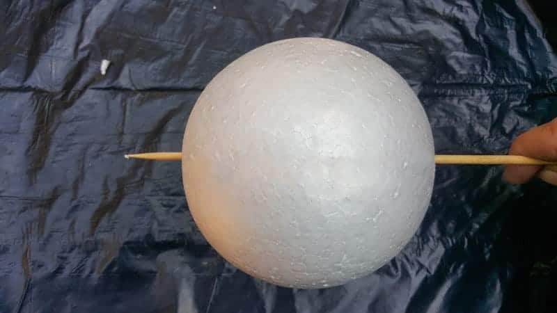 Stab a skewer through the polystyrene ball and place it on another piece of scrap polystyrene to make painting easier